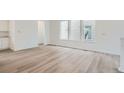 Spacious living room featuring hardwood floors, crisp white trim, and sun-drenched windows at 3127 S Russell St, Morrison, CO 80465