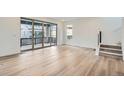 Open living room showcasing hardwood floors, deck access, and stairs to the upper level at 3127 S Russell St, Morrison, CO 80465
