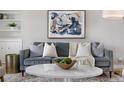 Living room featuring a modern gray sofa, marble coffee table, and stylish decor at 1295 Elm St, Denver, CO 80220