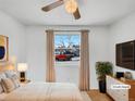 Bright, virtually staged bedroom with a ceiling fan, and a large window at 3118 S Joplin Ct, Aurora, CO 80013