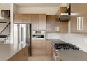 Modern kitchen boasting stainless steel appliances, light countertops, and custom cabinets at 11491 Alla Breve Cir, Lone Tree, CO 80134