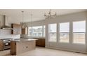Kitchen with stainless steel appliances, an island, light countertops, and lots of natural light at 11491 Alla Breve Cir, Lone Tree, CO 80134
