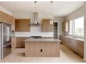 Bright kitchen featuring stainless steel appliances, an island, and sleek cabinets at 11491 Alla Breve Cir, Lone Tree, CO 80134