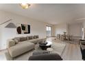 A tastefully furnished living room and dining area with wood-look floors and neutral color palette at 3840 Sierra Vista Rd, Monument, CO 80132