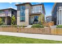 Stylish home with a mix of stone and siding, a balcony, gated front yard and inviting front porch at 21405 E 59Th Dr, Aurora, CO 80019