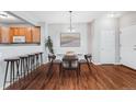 Bright dining area featuring hardwood floors, modern lighting, and views of the kitchen at 8237 W 54Th Ave # 2, Arvada, CO 80002