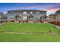 A row of townhomes features a shared front yard with drought-resistant landscaping at 8237 W 54Th Ave # 2, Arvada, CO 80002