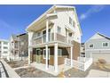 Corner view of a two-story home with a balcony and white picket fence at 17717 E 54Th Ave, Denver, CO 80249