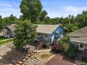 This aerial view captures the charm and character of this home surrounded by lush greenery at 3306 S Logan St, Englewood, CO 80113