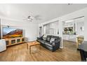 Bright living room featuring hardwood floors, a ceiling fan and an open layout at 3306 S Logan St, Englewood, CO 80113