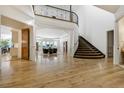 Bright foyer with hardwood floors and a sweeping staircase at 1328 E Layton Ave, Cherry Hills Village, CO 80113