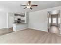 Open-concept living room offering ample space, neutral tones, and seamless flow into the kitchen at 869 Sawdust Dr, Brighton, CO 80601