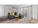 Cozy living room featuring a gray sectional sofa and access to a patio at 7995 E Mississippi Ave # G5, Denver, CO 80247