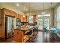 Well-lit kitchen with stainless steel appliances, a granite-topped island, and a dining area at 2479 S High St, Denver, CO 80210