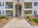 Close view of a condo entrance, showing stairs leading to upper units and well-kept grounds at 15700 E Jamison Dr # 7-203, Englewood, CO 80112