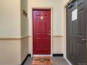 Entryway with a red door and a welcome mat, creating a warm and inviting atmosphere at 15700 E Jamison Dr # 7-203, Englewood, CO 80112
