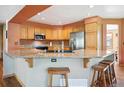 Well-equipped kitchen featuring granite countertops, stainless steel appliances, and a breakfast bar at 2397 Hearth Dr, Evergreen, CO 80439