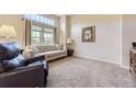 Bright living room boasts large window and neutral decor, perfect for comfortable living at 3912 Ute Mountain Trl, Castle Rock, CO 80109