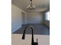 Bright dining room with hardwood floors and a modern chandelier at 16830 Mckay Dr, Mead, CO 80542