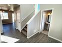 Bright entryway boasts wood floors, a staircase, and a convenient powder room at 16830 Mckay Dr, Mead, CO 80542