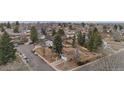 A neighborhood view from above, showcasing tree-lined streets and well-maintained homes in a suburban setting at 8785 E Floyd Cir, Denver, CO 80231