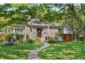 Charming home featuring a well-manicured lawn, stone walkway, and inviting front porch with an American flag at 675 Dahlia St, Denver, CO 80220