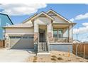 Single-Gathering home with stone accents, a covered porch, and a two-car garage in a desirable location at 4371 Soapberry Pl, Castle Rock, CO 80108