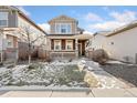 Two-story house with brown and beige siding, front yard, and walkway at 15842 E Warner Dr, Denver, CO 80239
