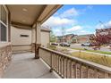 Inviting front porch view showcases the neighborhood streetscape on a sunny day at 15842 E Warner Dr, Denver, CO 80239