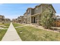 Street view of townhouses with manicured lawns and inviting walkways creating a picturesque and welcoming community at 4358 S Nepal Ct, Centennial, CO 80015