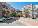 Attractive exterior view showcasing the building, balconies, parking, and landscaping at 5677 S Park Pl # A102, Englewood, CO 80111