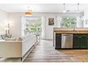Inviting living space with open layout, a dining area, and a sleek kitchen with stainless steel appliances at 5677 S Park Pl # A102, Englewood, CO 80111
