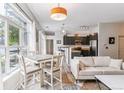 Bright living room with a dining table, modern furnishings, and large windows for natural light at 5677 S Park Pl # A102, Englewood, CO 80111