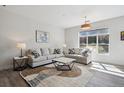 Bright living room with comfortable seating, large window, stylish rug, and contemporary decor at 5677 S Park Pl # A102, Englewood, CO 80111