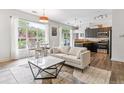 Stylish living room featuring a comfortable sofa, modern coffee table, and ample natural light from the large window at 5677 S Park Pl # A102, Englewood, CO 80111