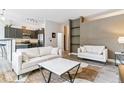 Spacious living room with modern sofas, an open kitchen, and stylish decor elements throughout the living space at 5677 S Park Pl # A102, Englewood, CO 80111