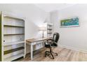 Functional home office with built-in bookshelves, a classic desk, and a comfortable executive chair at 5677 S Park Pl # A102, Englewood, CO 80111