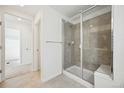 Modern bathroom with glass enclosed shower, tiled walls, and neutral color palette at 3325 N Coolidge Way, Aurora, CO 80019