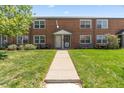 Charming two-story brick townhouse with a well-maintained front yard and inviting entrance at 2872 Jasmine St, Denver, CO 80207