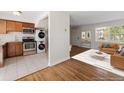 Inviting living room seamlessly connected to a kitchen with stacked laundry appliances at 2872 Jasmine St, Denver, CO 80207