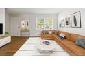 Cozy living room with large window, stylish decor, and hardwood floors at 2872 Jasmine St, Denver, CO 80207