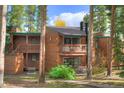 Inviting two-story condo with wood siding and private balconies nestled among the trees at 1080 Ski Hill Rd # 9, Breckenridge, CO 80424