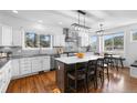 Modern kitchen with stainless steel appliances, island with seating and granite countertops at 30455 Telluride Ln, Evergreen, CO 80439