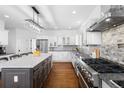 Modern kitchen with stainless steel appliances, granite countertops, and a large island at 30455 Telluride Ln, Evergreen, CO 80439