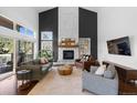 Inviting living room featuring high ceilings, a stone fireplace, and comfortable seating at 30455 Telluride Ln, Evergreen, CO 80439