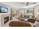 Bright living room with large windows, a cozy fireplace, and comfortable seating at 283 Pelican Cir # 1703, Breckenridge, CO 80424
