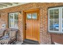 Inviting front entry with a beautiful wood door, sidelight windows, and a cozy seating area at 821 S High St, Denver, CO 80209