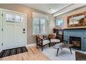 Cozy living room with wood floors, fireplace, comfortable seating, and natural light at 821 S High St, Denver, CO 80209