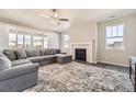 Spacious living room featuring a cozy fireplace and large windows at 2905 Morningbird Ln, Castle Rock, CO 80109