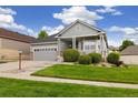 Charming single-Gathering home featuring a covered front porch, well-kept lawn, and attached two-car garage at 22166 E Chestnut Pl, Aurora, CO 80016